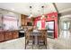Kitchen includes a granite island, stainless steel refrigerator and cabinet space at 10042 Pipestone St, Las Vegas, NV 89141