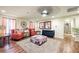 Comfortable living room with a ceiling fan, two chairs, carpet, and artwork at 10042 Pipestone St, Las Vegas, NV 89141