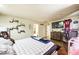 Cozy main bedroom with a TV, hardwood floors and lots of natural light at 10042 Pipestone St, Las Vegas, NV 89141