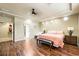 Spacious main bedroom with wood floors, recessed lighting, and a king-sized bed at 10042 Pipestone St, Las Vegas, NV 89141