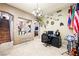 Office with tiled floors, desk, computer, and a display of flags and decorative items on the wall at 10042 Pipestone St, Las Vegas, NV 89141