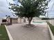 Backyard featuring a swimming pool, large tree, and paved patio area at 1338 Smoke Tree Ave, Las Vegas, NV 89108