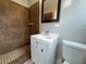 Bathroom featuring a modern sink, tiled shower, and updated fixtures at 1338 Smoke Tree Ave, Las Vegas, NV 89108
