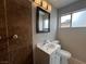 Updated bathroom with stylish vanity, mirror, and tiled shower at 1338 Smoke Tree Ave, Las Vegas, NV 89108