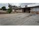 Single-story home featuring a spacious driveway, desert landscaping, and stone accents at 1338 Smoke Tree Ave, Las Vegas, NV 89108