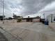 Traditional home with a large front yard, mature tree, and a partially fenced yard at 1338 Smoke Tree Ave, Las Vegas, NV 89108