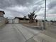 Wide view of house including front yard and driveway with manicured landscaping at 1338 Smoke Tree Ave, Las Vegas, NV 89108