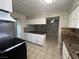 Bright kitchen featuring granite countertops, tiled flooring, ample cabinetry, and stainless steel appliances at 1338 Smoke Tree Ave, Las Vegas, NV 89108