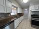 Traditional kitchen featuring stainless steel appliances, granite counters and white cabinets at 1338 Smoke Tree Ave, Las Vegas, NV 89108