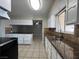 Bright kitchen featuring granite countertops, tiled flooring, ample cabinetry, and stainless steel sink at 1338 Smoke Tree Ave, Las Vegas, NV 89108