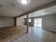 Spacious living room with tile flooring and sliding glass door to pool area at 1338 Smoke Tree Ave, Las Vegas, NV 89108
