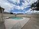 Backyard with a refreshing in-ground pool surrounded by concrete, enclosed by a privacy fence and open sky at 1338 Smoke Tree Ave, Las Vegas, NV 89108