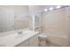 This bright bathroom features a single sink vanity, a toilet and a shower-tub combo at 1598 Cowboy Chaps Pl, Henderson, NV 89002