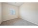 This bedroom features neutral carpet, a window, and ample natural light at 1598 Cowboy Chaps Pl, Henderson, NV 89002