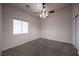 Bedroom showcases neutral carpet, ceiling fan, and window bringing in natural light at 1598 Cowboy Chaps Pl, Henderson, NV 89002