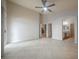 Spacious bedroom with ceiling fan, tile flooring, and access to bathroom and additional rooms at 1598 Cowboy Chaps Pl, Henderson, NV 89002