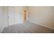 This carpeted bedroom features a closet with double doors and bright, neutral paint at 1598 Cowboy Chaps Pl, Henderson, NV 89002