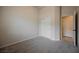 A carpeted bedroom with a sliding door closet and an open doorway at 1598 Cowboy Chaps Pl, Henderson, NV 89002