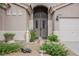 Up-close view of the front door and front yard including landscaping at 1598 Cowboy Chaps Pl, Henderson, NV 89002