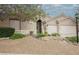 Charming home featuring rock landscaping, mature trees, and a secure gated entrance at 1598 Cowboy Chaps Pl, Henderson, NV 89002