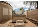 Hot tub situated on a paver patio surrounded by a block wall and landscaping at 1598 Cowboy Chaps Pl, Henderson, NV 89002