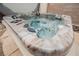 This spa-like hot tub features multiple seats and hydrotherapy jets at 1598 Cowboy Chaps Pl, Henderson, NV 89002