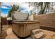 Backyard featuring a hot tub with an open lid on a stone paver patio at 1598 Cowboy Chaps Pl, Henderson, NV 89002