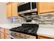 Close up on the stainless gas range and microwave oven in the kitchen at 1598 Cowboy Chaps Pl, Henderson, NV 89002