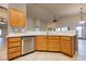 Bright kitchen features wooden cabinets, stainless steel dishwasher, and ample counter space at 1598 Cowboy Chaps Pl, Henderson, NV 89002