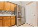 Stainless steel refrigerator with water dispenser and cabinet space in kitchen at 1598 Cowboy Chaps Pl, Henderson, NV 89002