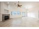 Bright and airy living area featuring a fireplace, large windows, and sliding door access at 1598 Cowboy Chaps Pl, Henderson, NV 89002
