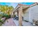 Charming covered back patio area with decorative stone pillars, an outdoor dining set, and sliding door access to the house at 2253 Van Gogh Dr, Henderson, NV 89074