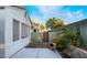 View of the private back yard with lush green plants and stucco wall at 2253 Van Gogh Dr, Henderson, NV 89074