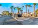 Elegant entrance to a gated community with lush landscaping, palm trees and attractive signage at 2253 Van Gogh Dr, Henderson, NV 89074
