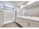 Bright bathroom featuring double vanity, large mirror, and walk-in shower at 2523 Campaldo St, Henderson, NV 89044