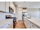 Bright kitchen featuring an island, white cabinetry, stainless appliances, and hardwood floors at 2523 Campaldo St, Henderson, NV 89044