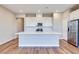 Kitchen featuring white cabinets, a center island, stainless steel appliances, and hardwood floors at 2523 Campaldo St, Henderson, NV 89044