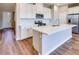 Kitchen featuring white cabinets, a center island, stainless steel appliances, and hardwood floors at 2523 Campaldo St, Henderson, NV 89044