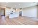 Open-concept kitchen and living room with hardwood floors, stainless appliances, and recessed lighting at 2523 Campaldo St, Henderson, NV 89044