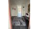 View of the entryway with a long hallway, rug, bench, and artwork on the walls at 2755 Atomic Tangerine Way # 2, Las Vegas, NV 89183