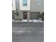 Neutral-toned townhome featuring a garage, front door, and minimalist landscaping at 2755 Atomic Tangerine Way # 2, Las Vegas, NV 89183