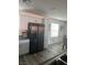 Modern kitchen with stainless steel appliances, white cabinets, and a dining area nearby at 2755 Atomic Tangerine Way # 2, Las Vegas, NV 89183