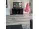 A living room with a mounted TV, stylish cabinet, and festive pink Christmas tree at 2755 Atomic Tangerine Way # 2, Las Vegas, NV 89183