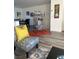 An inviting living room with a colorful chair and a decorative birdcage at 2755 Atomic Tangerine Way # 2, Las Vegas, NV 89183