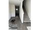 Open-concept living area with stairs, neutral walls, and modern flooring with a dog at 2755 Atomic Tangerine Way # 2, Las Vegas, NV 89183