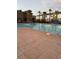 A community pool with palm trees and comfortable lounge chairs, perfect for relaxation at 2755 Atomic Tangerine Way # 2, Las Vegas, NV 89183