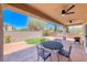 Covered patio with dining furniture providing a perfect spot for outdoor relaxation, adjacent to green space at 3001 Walnut Park Ct, Henderson, NV 89052