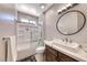Bathroom featuring vanity with undermount sink and framed mirror, complemented by a shower-tub combo at 3001 Walnut Park Ct, Henderson, NV 89052