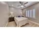 Comfortable bedroom with ceiling fan and shutters allowing natural light to filter through the window at 3001 Walnut Park Ct, Henderson, NV 89052