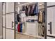 Well organized closet with hanging rods, shelving, drawers, and metal and white barn door at 3001 Walnut Park Ct, Henderson, NV 89052
